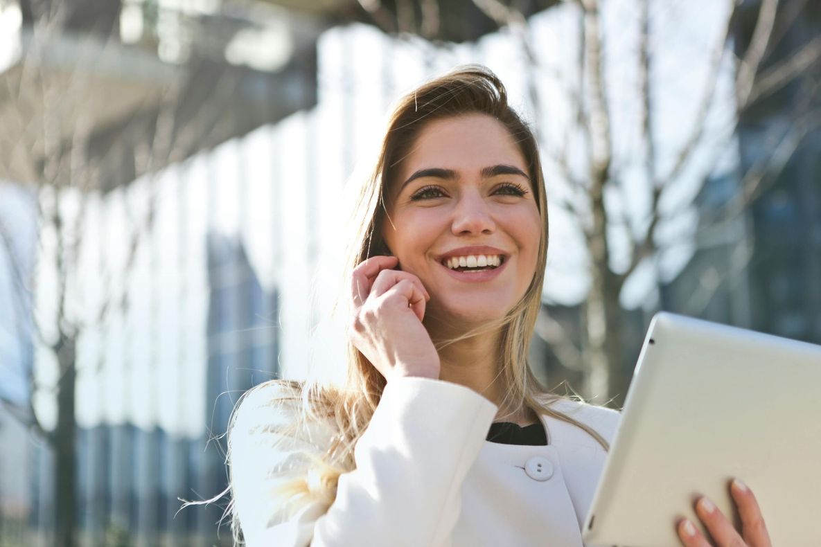 Mujer sonriendo mientras habla por teléfono